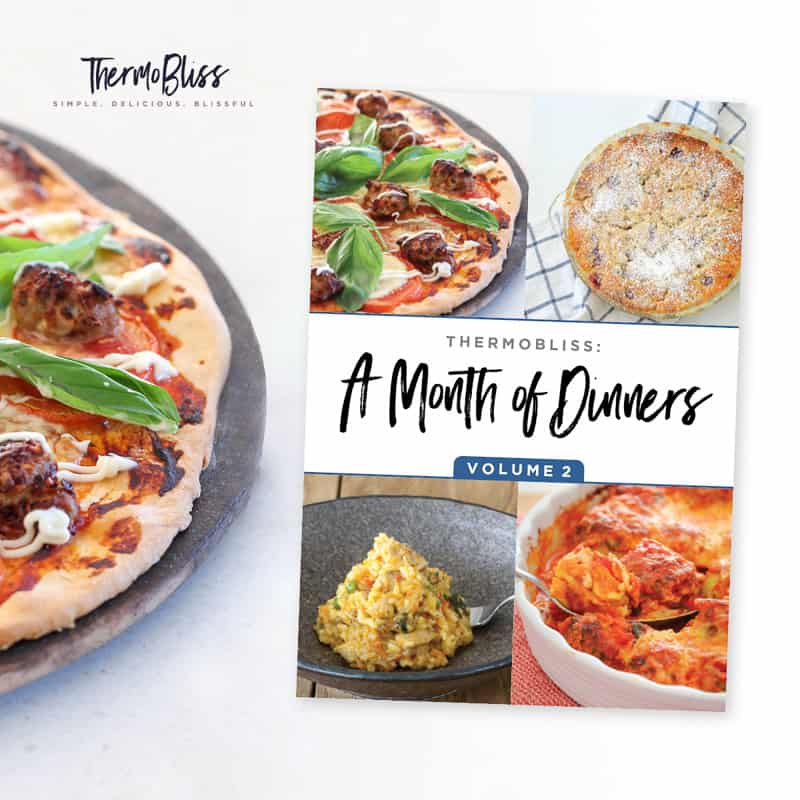 A ThermoBliss Dinners cookbook next to a pizza on a tray